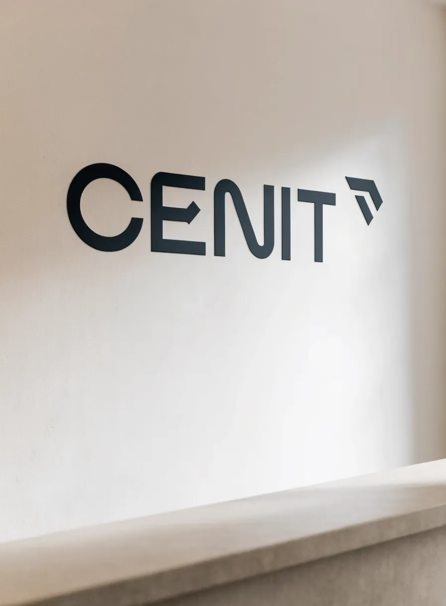 letras corpóreas planas con el nombre de la marca ficticia CENIT montadas al ras sobre el muro claro de una recepción